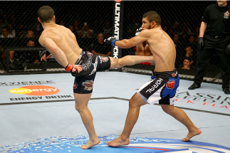 TORONTO, CANADA - SEPTEMBER 21: (L-R) John Makdessi kicks Renee Forte in their UFC lightweight bout at the Air Canada Center on September 21, 2013 in Toronto, Ontario, Canada. (Photo by Al Bello/Zuffa LLC/Zuffa LLC via Getty Images) *** Local Caption ***