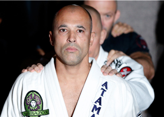 LAS VEGAS, NV - NOVEMBER 13: UFC legend Royce Gracie prepares to lead UFC welterweight champion Georges St-Pierre onto the stage before an open workout session for media inside the Hollywood Theatre at the MGM Grand Hotel/Casino on November 13, 2013 in La