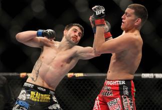 LAS VEGAS - FEBRUARY 04: Carlos Condit (left) punches Nick Diaz during the UFC 143 event at Mandalay Bay Events Center on February 4, 2012 in Las Vegas, Nevada. (Photo by Josh Hedges/Zuffa LLC/Zuffa LLC via Getty Images) *** Local Caption *** Carlos Con