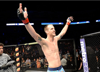 DULUTH, GA - JANUARY 15:  Cole Miller reacts after the win against Sam Sicilia in their featherweight fight during the UFC Fight Night event inside The Arena at Gwinnett Center on January 15, 2014 in Duluth, Georgia. (Photo by Jeff Bottari/Zuffa LLC/Zuffa