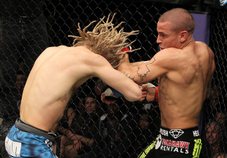 LAS VEGAS, NV - DECEMBER 15: (R-L) Dustin Poirier punches Jonathan Brookins during their featherweight fight at the TUF 16 Finale on December 15, 2012 at the Joint at the Hard Rock in Las Vegas, Nevada. (Photo by Jim Kemper/Zuffa LLC/Zuffa LLC via Gett