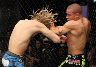 LAS VEGAS, NV - DECEMBER 15:  (R-L) Dustin Poirier punches Jonathan Brookins during their featherweight fight at the TUF 16 Finale on December 15, 2012  at the Joint at the Hard Rock in Las Vegas, Nevada.  (Photo by Jim Kemper/Zuffa LLC/Zuffa LLC via Gett