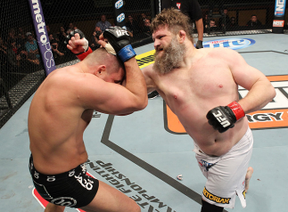 LAS VEGAS, NV - DECEMBER 15: (R-L) Roy Nelson punches Matt Mitrione during their heavyweight fight at the TUF 16 Finale on December 15, 2012 at the Joint at the Hard Rock in Las Vegas, Nevada. (Photo by Jim Kemper/Zuffa LLC/Zuffa LLC via Getty Images)