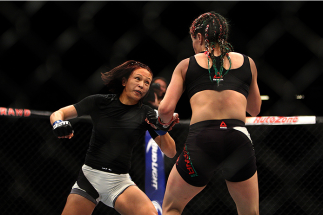 LAS VEGAS, NV - JULY 12: (L-R) Michelle Waterson punches Angela Magana in their women's strawweight bout during the Ultimate Fighter Finale inside MGM Grand Garden Arena on July 12, 2015 in Las Vegas, Nevada. (Photo by Mitch Viquez/Zuffa LLC/Zuffa LLC v