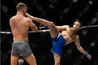 LAS VEGAS, NV - DECEMBER 11: (R-L) Ryan Hall kicks Artem Lobov in their lightweight finals bout during the TUF Finale event inside The Chelsea at The Cosmopolitan of Las Vegas on December 11, 2015 in Las Vegas, Nevada.  (Photo by Brandon Magnus/Zuffa LLC/