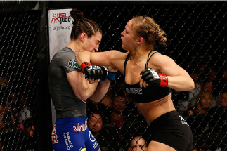 LAS VEGAS, NV - FEBRUARY 22:  Ronda Rousey (right) elbows Sara McMann in their women's bantamweight championship bout during UFC 170 inside the Mandalay Bay Events Center on February 22, 2014 in Las Vegas, Nevada. (Photo by Josh Hedges/Zuffa LLC/Zuffa LLC