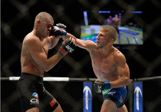 LAS VEGAS, NV - MAY 24: T.J. Dillashaw punches Renan Barao in their bantamweight championship bout during the UFC 173 event at the MGM Grand Garden Arena on May 24, 2014 in Las Vegas, Nevada. (Photo by Jeff Bottari/Zuffa LLC/Zuffa LLC via Getty Images)
