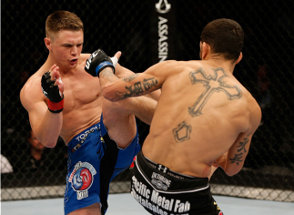 SACRAMENTO, CA - AUGUST 30: (L-R) Chris Wade kicks the mid-section of Cain Carrizosa in their lightweight bout during the UFC 177 event at Sleep Train Arena on August 30, 2014 in Sacramento, California. (Photo by Josh Hedges/Zuffa LLC/Zuffa LLC via Gett