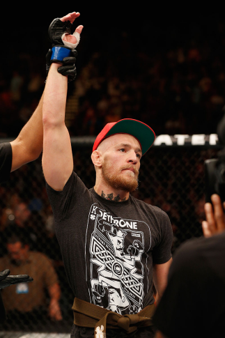 LAS VEGAS, NV - SEPTEMBER 27: Conor McGregor celebrates after his TKO win against Dustin Poirier after their featherweight fight during the UFC 178 event inside the MGM Grand Garden Arena on September 27, 2014 in Las Vegas, Nevada. (Photo by Josh Hedges