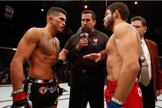 LAS VEGAS, NV - DECEMBER 06:  (L-R) Anthony Pettis and Gilbert Melendez face off in their UFC lightweight championship bout during the UFC 181 event inside the Mandalay Bay Events Center on December 6, 2014 in Las Vegas, Nevada.  (Photo by Josh Hedges/Zuf