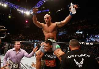 LAS VEGAS, NV - DECEMBER 06: Robbie Lawler (center) celebrates his victory in his UFC welterweight championship bout during the UFC 181 event inside the Mandalay Bay Events Center on December 6, 2014 in Las Vegas, Nevada. (Photo by Josh Hedges/Zuffa LLC