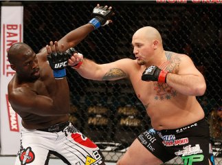 LAS VEGAS, NV - JANUARY 03: (R-L) Shawn Jordan punches Jared Cannonier in their heavyweight bout during the UFC 182 event at the MGM Grand Garden Arena on January 3, 2015 in Las Vegas, Nevada. (Photo by Josh Hedges/Zuffa LLC/Zuffa LLC via Getty Images)
