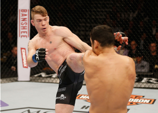 LAS VEGAS, NV - JANUARY 03: (L-R) Paul Felder kicks Danny Castillo in their lightweight bout during the UFC 182 event at the MGM Grand Garden Arena on January 3, 2015 in Las Vegas, Nevada. (Photo by Josh Hedges/Zuffa LLC/Zuffa LLC via Getty Images)