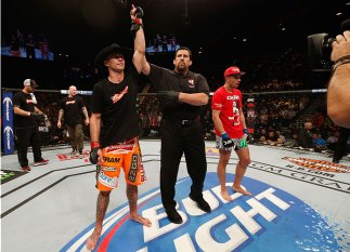 LAS VEGAS, NV - JANUARY 03: (L-R) Donald Cerrone celebrates his victory over Myles Jury in their lightweight bout during the UFC 182 event on at the MGM Grand Garden Arena January 3, 2015 in Las Vegas, Nevada. (Photo by Josh Hedges/Zuffa LLC/Zuffa LLC v