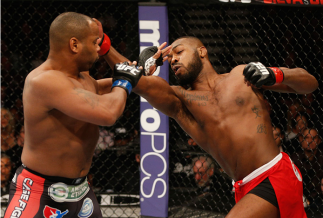 LAS VEGAS, NV - JANUARY 03:  (R-L) UFC light heavyweight championJon Jones punches Daniel Cormier in their UFC light heavyweight championship bout during the UFC 182 event at the MGM Grand Garden Arena on January 3, 2015 in Las Vegas, Nevada.  (Photo by J