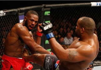 LAS VEGAS, NV - JANUARY 03: Daniel Cormier (R) kicks Jon Jones (L) in their UFC light heavyweight championship bout during the UFC 182 event at the MGM Grand Garden Arena on January 3, 2015 in Las Vegas, Nevada. (Photo by Josh Hedges/Zuffa LLC/Zuffa LLC