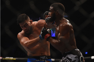 LAS VEGAS, NV - JANUARY 31: (R-L) Tyron Woodley punches Kelvin Gastelum in their welterweight bout during the UFC 183 event at the MGM Grand Garden Arena on January 31, 2015 in Las Vegas, Nevada. (Photo by Jeff Bottari/Zuffa LLC/Zuffa LLC via Getty Imag