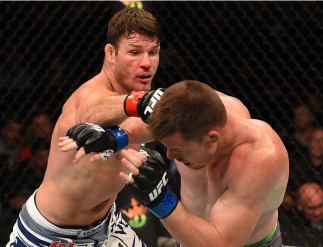 MONTREAL, QC - APRIL 25: (L-R) Michael Bisping of England punches CB Dollaway of the United States in their middleweight bout during the UFC 186 event at the Bell Centre on April 25, 2015 in Montreal, Quebec, Canada. (Photo by Josh Hedges/Zuffa LLC/Zuff