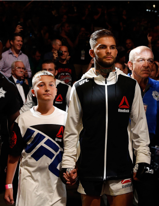 LAS VEGAS, NV - JULY 11: Cody Garbrandt and a young fan walk to the Octagon during the UFC 189 event inside MGM Grand Garden Arena on July 11, 2015 in Las Vegas, Nevada. (Photo by Christian Petersen/Zuffa LLC/Zuffa LLC via Getty Images) *** Local Captio