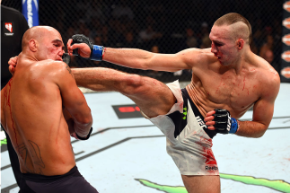 LAS VEGAS, NV - JULY 11: (R-L) Rory MacDonald kicks Robbie Lawler in their UFC welterweight title fight during the UFC 189 event inside MGM Grand Garden Arena on July 11, 2015 in Las Vegas, Nevada. (Photo by Josh Hedges/Zuffa LLC/Zuffa LLC via Getty Ima