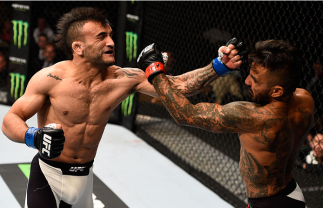 LAS VEGAS, NV - SEPTEMBER 05: (L-R) John Lineker and Francisco Rivera exchange punches in their bantamweight bout during the UFC 191 event inside MGM Grand Garden Arena on September 5, 2015 in Las Vegas, Nevada. (Photo by Jeff Bottari/Zuffa LLC/Zuffa LLC