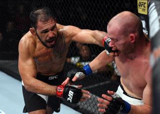 CURITIBA, BRAZIL - MAY 14: (L-R) Antonio Rogerio Nogueira of Brazil punches Patrick Cummins in their light heavyweight bout during the UFC 198 event at Arena da Baixada stadium on May 14, 2016 in Curitiba, Parana, Brazil. (Photo by Josh Hedges/Zuffa LLC