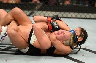 LAS VEGAS, NV - MARCH 04: Cynthia Calvillo (black) attempts to submit Amanda Cooper in their women's strawweight bout during the UFC 209 event at T-Mobile Arena on March 4, 2017 in Las Vegas, Nevada. (Photo by Josh Hedges/Zuffa LLC/Zuffa LLC via Getty I