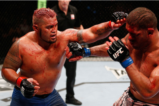 BRISBANE, AUSTRALIA - DECEMBER 07: (L-R) Mark Hunt punches Antonio "Bigfoot" Silva in their heavyweight fight during the UFC Fight Night event at the Brisbane Entertainment Centre on December 7, 2013 in Brisbane, Australia. (Photo by Josh Hedges/Zuffa LL