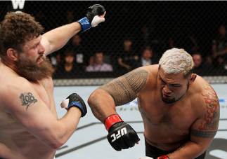 SAITAMA, JAPAN - SEPTEMBER 20: Mark Hunt throws a punch at Roy Nelson in their heavyweight bout during the UFC Fight Night event inside the Saitama Arena on September 20, 2014 in Saitama, Japan. (Photo by Mitch Viquez/Zuffa LLC/Zuffa LLC via Getty Images