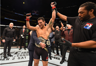 ORLANDO, FL - DECEMBER 19:   Rafael dos Anjos celebrates his TKO victory over Donald Cerrone in their UFC lightweight title bout during the UFC Fight Night event at the Amway Center on December 19, 2015 in Orlando, Florida. (Photo by Josh Hedges/Zuffa LLC