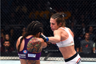 PHOENIX, AZ - DECEMBER 13: (R-L) Joanna Jedrzejczyk of Poland punches Claudia Gadelha of Brazil in their women's strawweight fight during the UFC Fight Night event at the U.S. Airways Center on December 13, 2014 in Phoenix, Arizona. (Photo by Josh Hedge