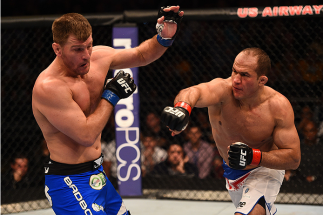 PHOENIX, AZ - DECEMBER 13: (R-L) Junior Dos Santos of Brazil punches Stipe Miocic in their heavyweight fight during the UFC Fight Night event at the U.S. Airways Center on December 13, 2014 in Phoenix, Arizona. (Photo by Josh Hedges/Zuffa LLC/Zuffa LLC