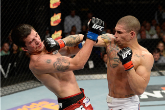 ATLANTIC CITY, NJ - JULY 16: (R-L) Lucas Martins punches Alex White in their featherweight bout during the UFC Fight Night event at Revel Casino on July 16, 2014 in Atlantic City, New Jersey. (Photo by Jeff Bottari/Zuffa LLC/Zuffa LLC via Getty Images)