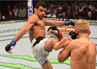 CHICAGO, IL - JULY 25: (L-R) Renan Barao of Brazil kicks TJ Dillashaw in their UFC bantamweight championship bout during the UFC event at the United Center on July 25, 2015 in Chicago, Illinois. (Photo by Jeff Bottari/Zuffa LLC/Zuffa LLC via Getty Image