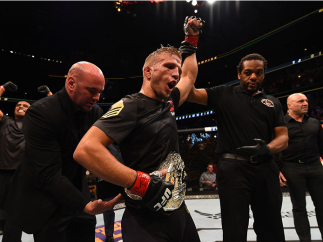 CHICAGO, IL - JULY 25:   TJ Dillashaw celebrates after his TKO victory over Renan Barao of Brazil UFC bantamweight championship bout during the UFC event at the United Center on July 25, 2015 in Chicago, Illinois. (Photo by Jeff Bottari/Zuffa LLC/Zuffa LL