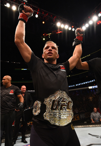 CHICAGO, IL - JULY 25: TJ Dillashaw celebrates after his TKO victory over Renan Barao of Brazil UFC bantamweight championship bout during the UFC event at the United Center on July 25, 2015 in Chicago, Illinois. (Photo by Jeff Bottari/Zuffa LLC/Zuffa LL