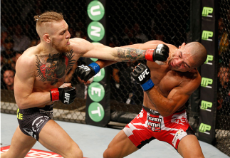 DUBLIN, IRELAND - JULY 19: (L-R) Conor McGregor lands a left to the head of Diego Brandao in their featherweight bout during the UFC Fight Night event at The O2 Dublin on July 19, 2014 in Dublin, Ireland. (Photo by Josh Hedges/Zuffa LLC/Zuffa LLC via Ge