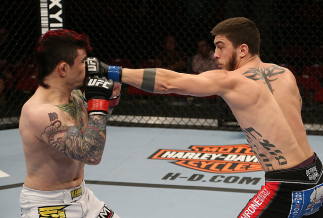 SEATTLE, WA - DECEMBER 08: (R-L) John Albert punches Scott Jorgensen during their bantamweight bout at the UFC on FOX event on December 8, 2012 at Key Arena in Seattle, Washington. (Photo by Ezra Shaw/Zuffa LLC/Zuffa LLC via Getty Images) *** Local Cap