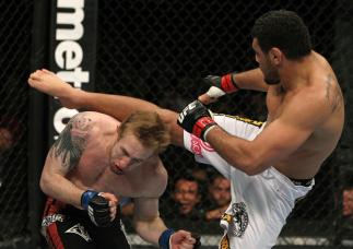 NASHVILLE, TN - JANUARY 20: (R-L) Fabricio Camoes kicks Tommy Hayden during the UFC on FX event at Bridgestone Arena on January 20, 2012 in Nashville, Tennessee. (Photo by Josh Hedges/Zuffa LLC/Zuffa LLC via Getty Images)