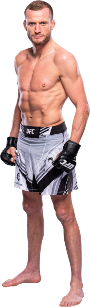 A side body photo of Davey Grant in white UFC gear