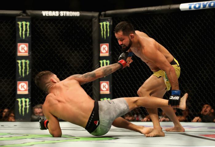 Jussier Formiga stands over Sergio Pettis in their flyweight bout during the UFC 229 event inside T-Mobile Arena on October 6, 2018 in Las Vegas, Nevada.