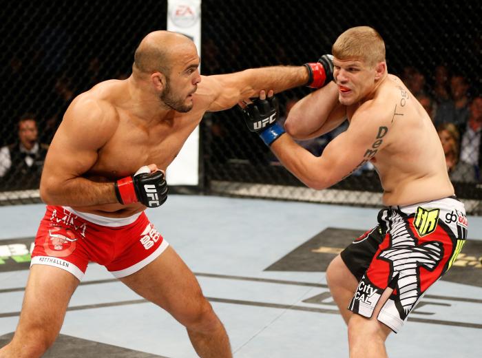 Ilir Latifi punches Chris Dempsey in their light heavyweight bout during the UFC Fight Night event at The O2 Dublin on July 19, 2014 in Dublin, Ireland.