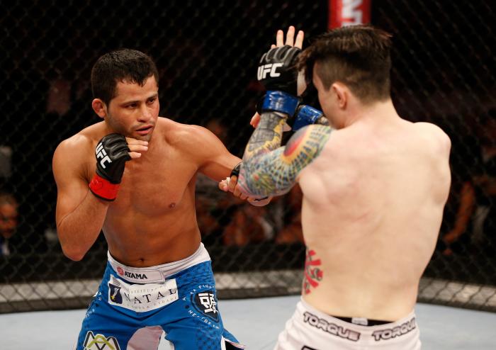 NATAL, BRAZIL - MARCH 23: (R-L) Jussier Formiga punches Scott Jorgensen in their flyweight bout during the UFC Fight Night event at Ginasio Nelio Dias on March 23, 2014 in Natal, Brazil. (Photo by Josh Hedges/Zuffa LLC via Getty Images)