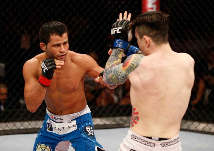 NATAL, BRAZIL - MARCH 23:  (R-L) Jussier Formiga punches Scott Jorgensen in their flyweight bout during the UFC Fight Night event at Ginasio Nelio Dias on March 23, 2014 in Natal, Brazil. (Photo by Josh Hedges/Zuffa LLC via Getty Images) 