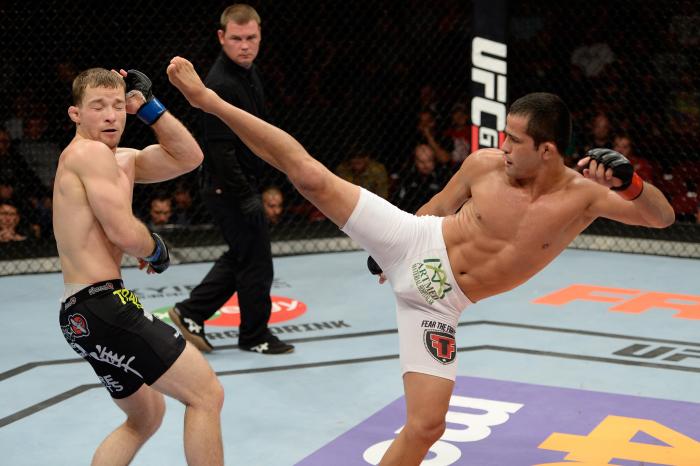 BANGOR, ME - AUGUST 16: (R-L) Jussier Formiga kicks Zach Makovsky in their flyweight bout during the UFC fight night event at the Cross Insurance Center on August 16, 2014 in Bangor, Maine. (Photo by Jeff Bottari/Zuffa LLC via Getty Images)