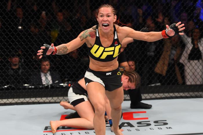 CURITIBA, BRAZIL - MAY 14:  (L-R) Cristiane 'Cyborg' Justino of Brazil celebrates after defeating Leslie Smith in their women's catchweight bout during the UFC 198 event at Arena da Baixada stadium on May 14, 2016 in Curitiba, Parana, Brazil.  (Photo by Josh Hedges/Zuffa LLC via Getty Images)