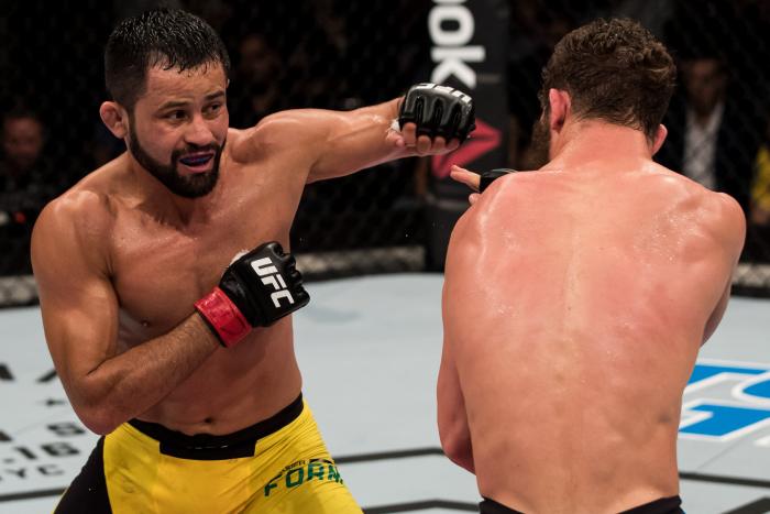 BRASILIA, BRAZIL - SEPTEMBER 24: Jussier Formiga of Brazil punches Dustin Ortiz of the United States in their bantamweight UFC bout during the UFC Fight Night event at Nilson Nelson gymnasium on September 24, 2016 in Brasilia, Brazil. (Photo by Buda Mendes/Zuffa LLC via Getty Images)