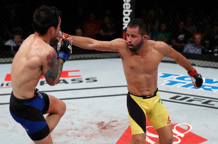 FORTALEZA, BRAZIL - MARCH 11:  (R-L) Jussier Formiga of Brazil lands a spinning back fist against Ray Borg in their flyweight bout during the UFC Fight Night event at CFO - Centro de Forma?co Olimpica on March 11, 2017 in Fortaleza, Brazil. (Photo by Buda Mendes/Zuffa LLC via Getty Images)