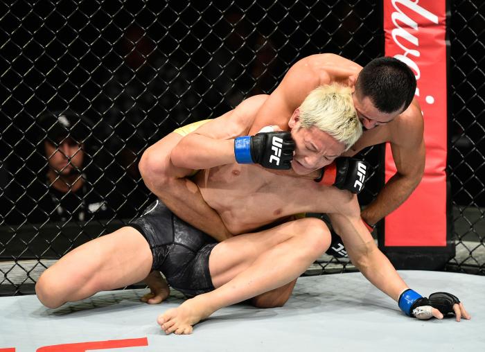 SAITAMA, JAPAN - SEPTEMBER 22:  Jussier Formiga of Brazil (top) controls the body of Ulka Sasaki of Japan in their featherweight bout during the UFC Fight Night event inside the Saitama Super Arena on September 22, 2017 in Saitama, Japan. (Photo by Jeff Bottari/Zuffa LLC via Getty Images)