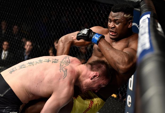 BOSTON, MA - JANUARY 20: (L-R) Stipe Miocic takes down Francis Ngannou of Cameroon in their heavyweight championship bout during the UFC 220 event at TD Garden on January 20, 2018 in Boston, Massachusetts. (Photo by Jeff Bottari/Zuffa LLC via Getty Images)